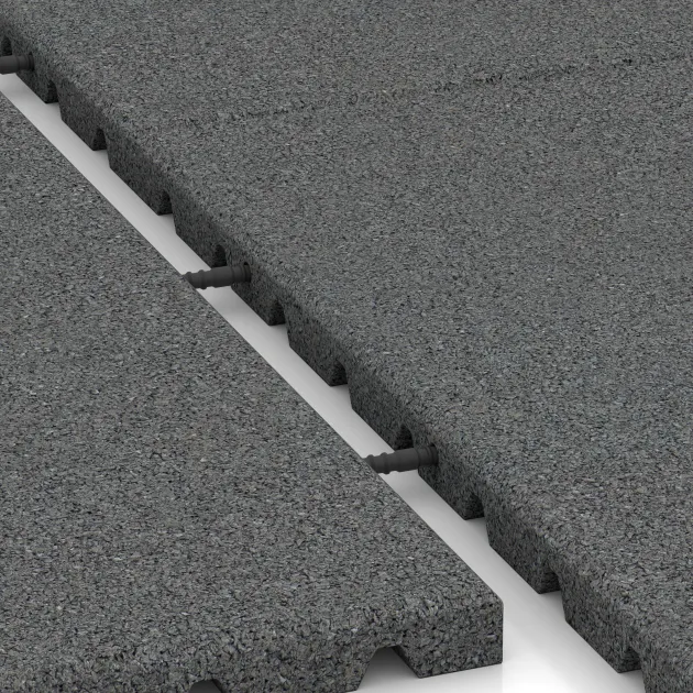 Le gros plan sur le système de connexion des revêtements de sol WARCO 5658 - Dalle de sécurité 3 cm - EN 1177 ≤ 90 cm en couleur Gris ardoise. Les dimensions 1000 x 1000 x 30 mm.